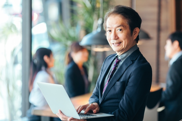 パソコンで仕事に集中している中年男性